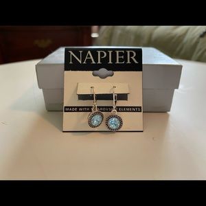 Silver colored dangle earrings with blue stone